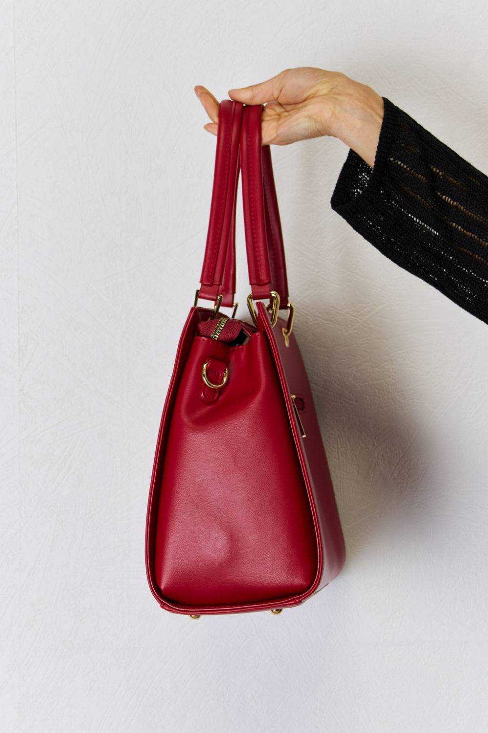 Red PU leather handbag with textured finish and gold hardware, medium size, versatile handles.